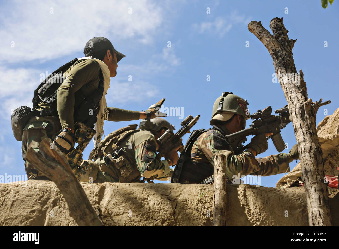 Afghan National Army Special Forces with the 6th Special Operations Kandak return fire during a gun battle May 27, 2014 in the Nejrab district, Kapisa province, Afghanistan. Stock Photo