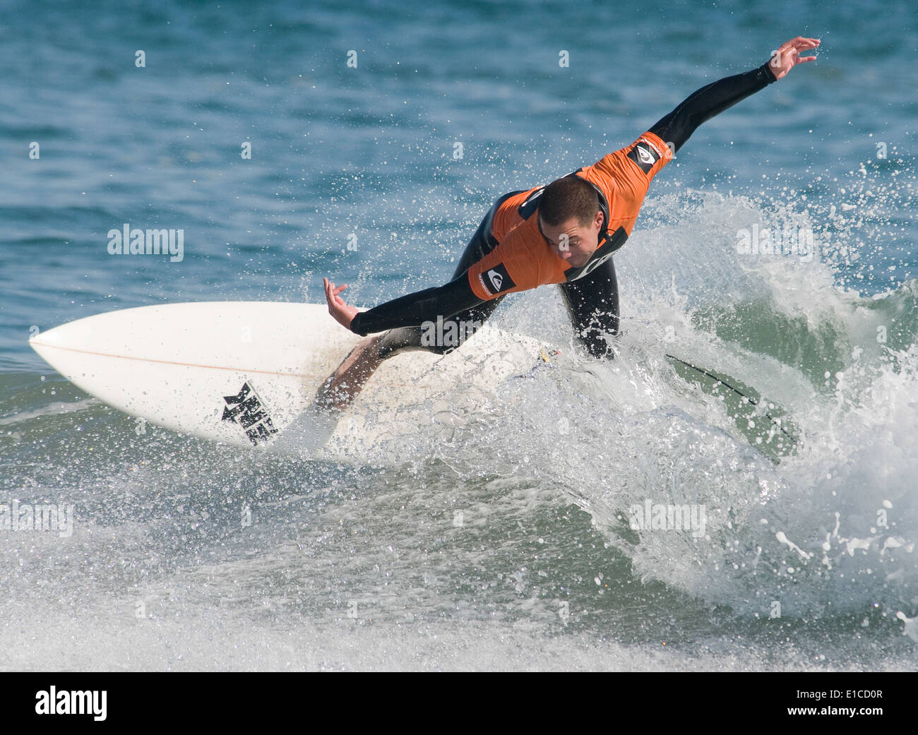 U.S. Navy Machinery Technician 2nd Class Matthew Merel surfs during a preliminary heat in the military men?s division of the Po Stock Photo