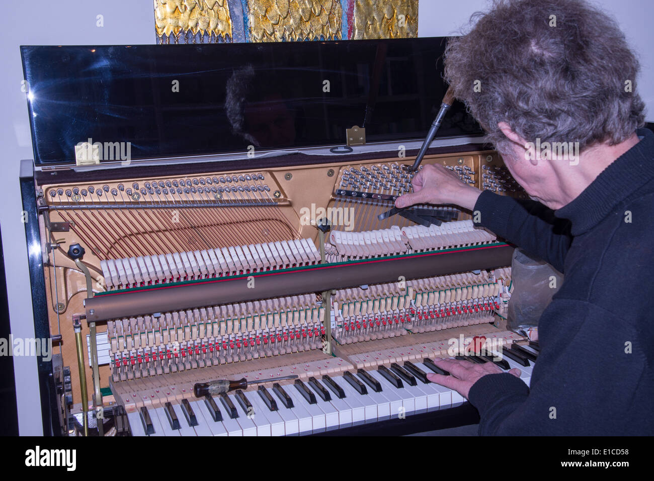a tuner at work with a piano Stock Photo