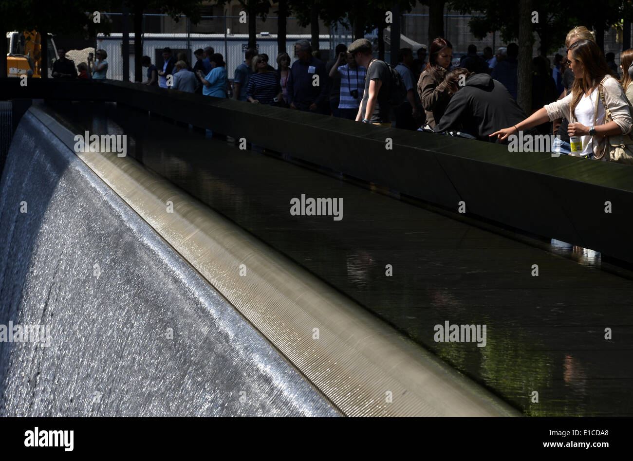 New York, USA. 30th May, 2014. People visit the south reflecting pool at the Ground Zero in New York, the United States, May 30, 2014. A wreath laying ceremony was held in honor of the thousands of rescue and recovery workers to mark the 12th anniversary of the official end of the rescue and recovery effort. On May 30, 2002, the Last Column was the final piece of steel to be removed from Ground Zero. Credit:  Wang Lei/Xinhua/Alamy Live News Stock Photo