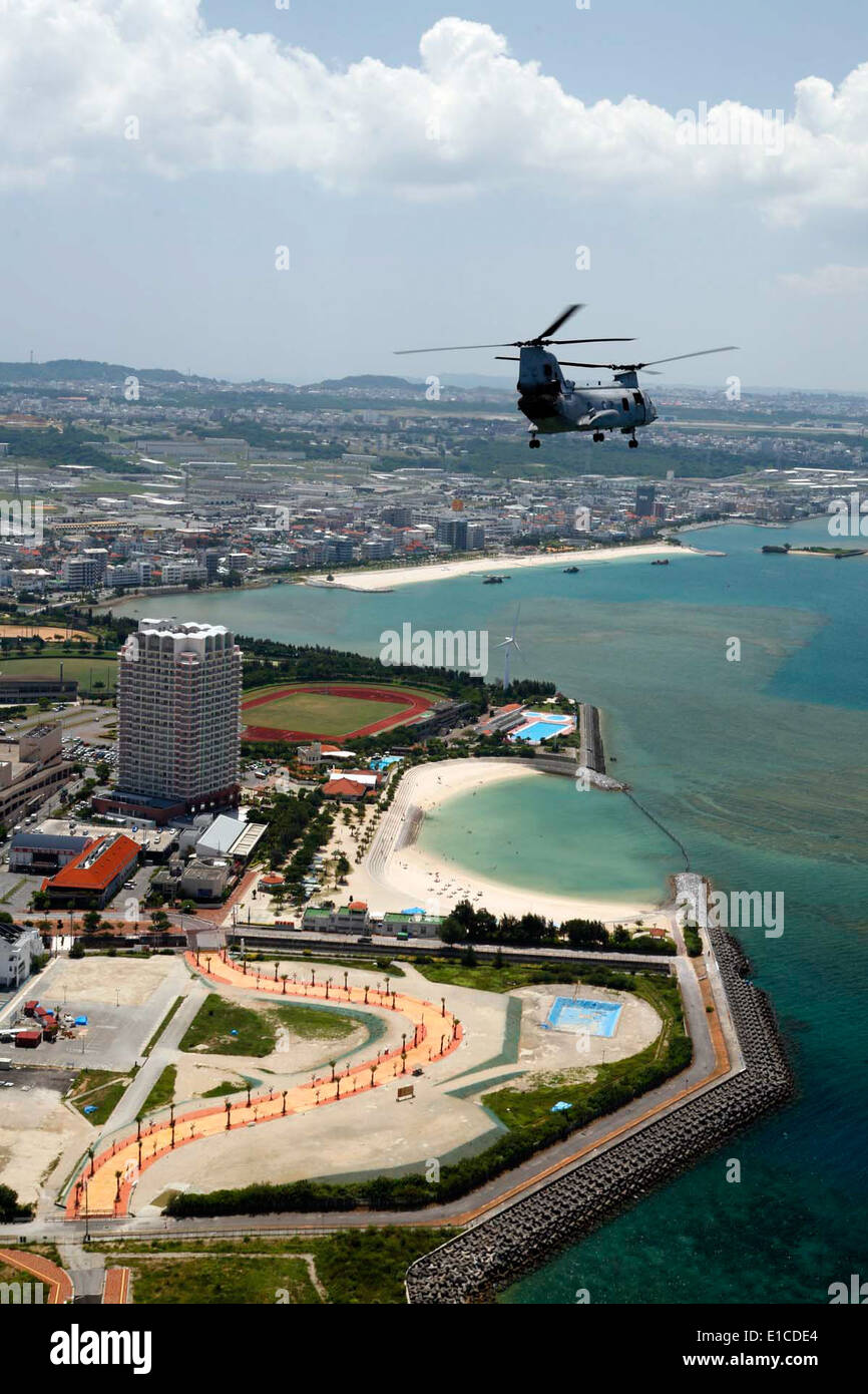 A CH-46 Sea Knight helicopter carrying Secretary of the Navy Ray Mabus flies by Mihama American Village in Okinawa, Japan, Aug. Stock Photo