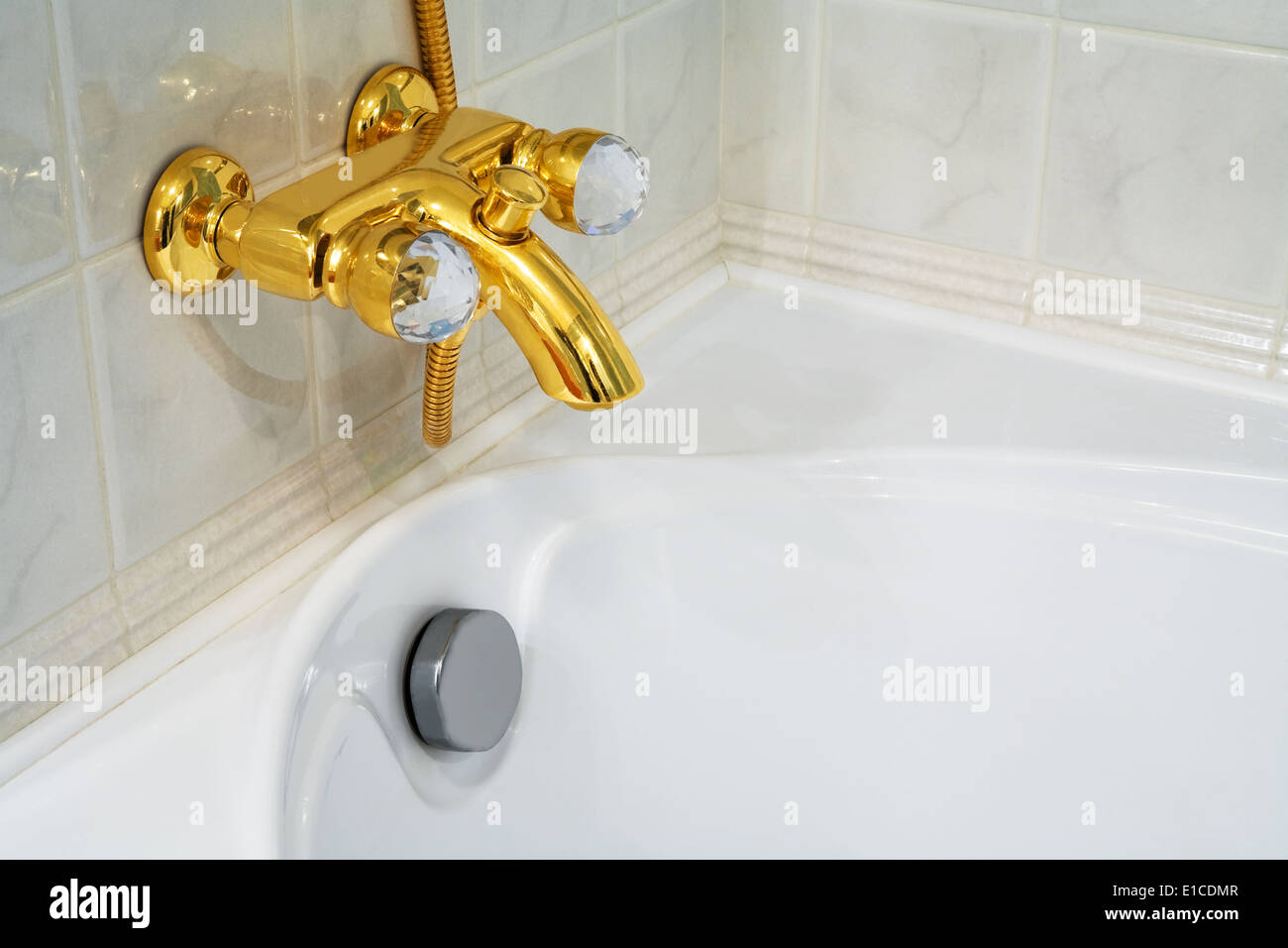 The beautiful bronze faucet and white bath Stock Photo
