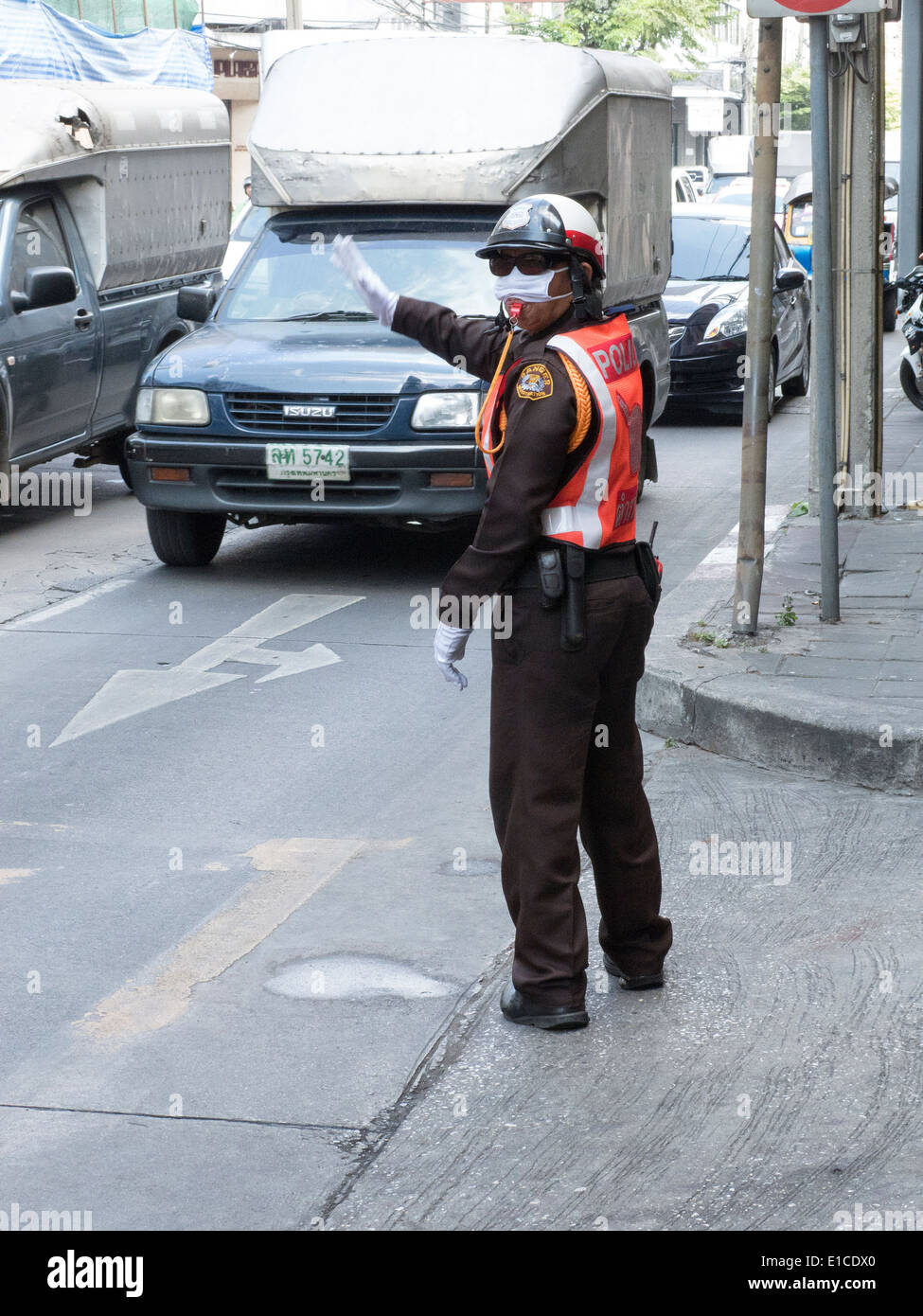 Thailand law enforcement Thai police officer standing on the roadside in Bangkok Thailand Stock Photo