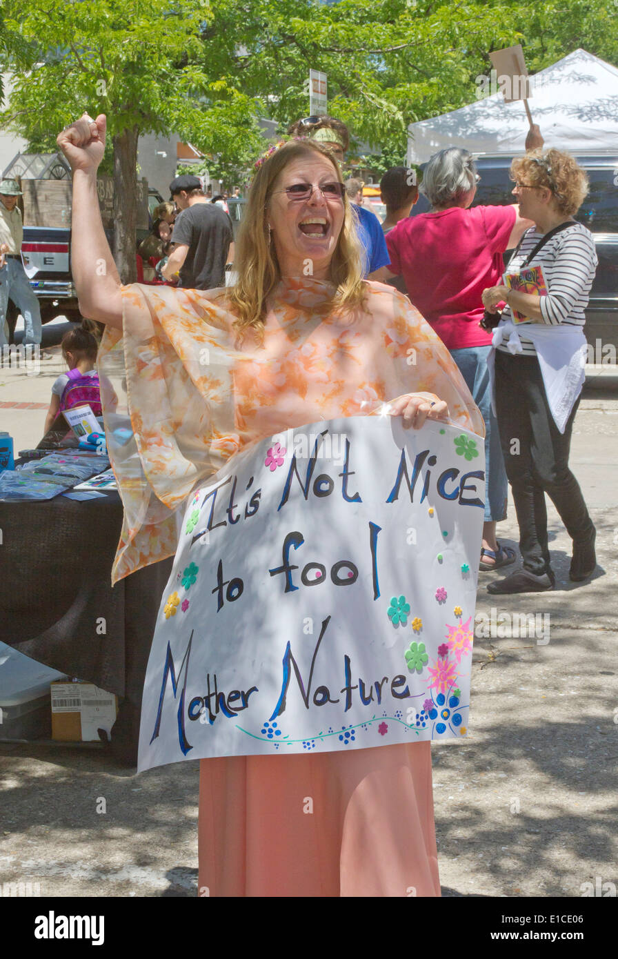 Woman holds a sign saying 'It's Not Nice to Fool Mother Nature!' at a GMO and Monsanto protest rally in Asheville, NC Stock Photo