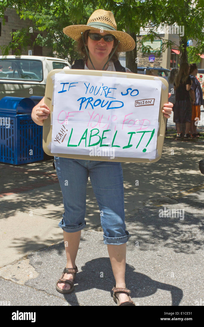 Asheville, NC, USA - May 24, 2014: Woman holds a GMO protest sign demanding that GMO food be labeled Stock Photo