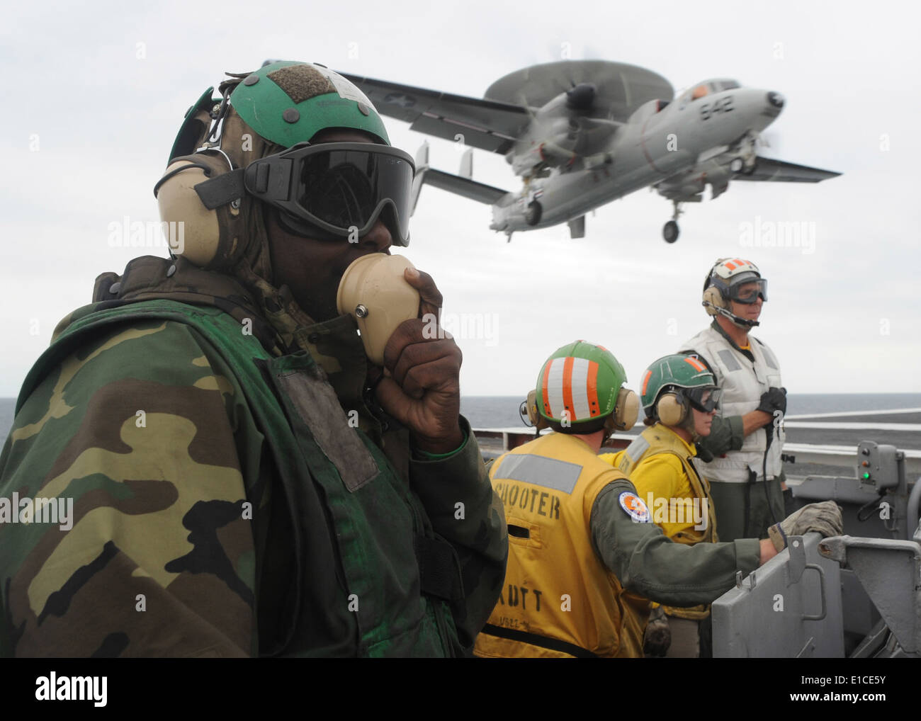 U.S. Navy Aviation Boatswain's Mate (Equipment) 3rd Class Quasi Alexander communicates through a