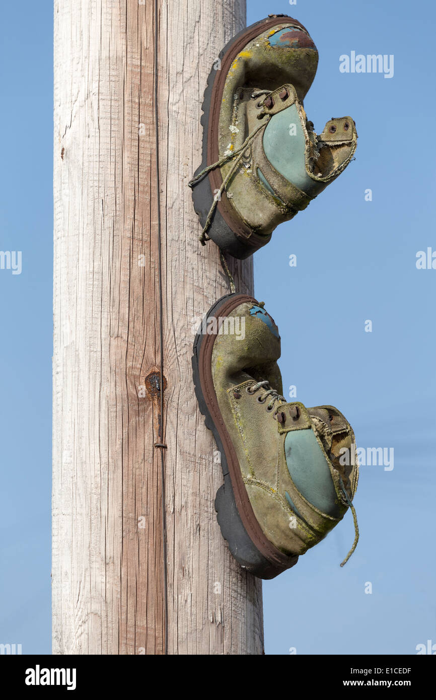 Boots nailed to Lamppost depicting a meeting place for gangs and drug dealers Stock Photo