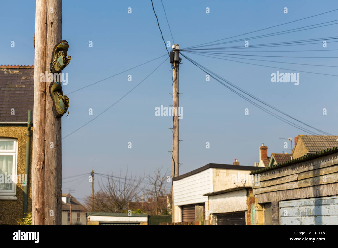 Boots on Lamppost depicting a meeting place for gangs and drug dealers Stock Photo