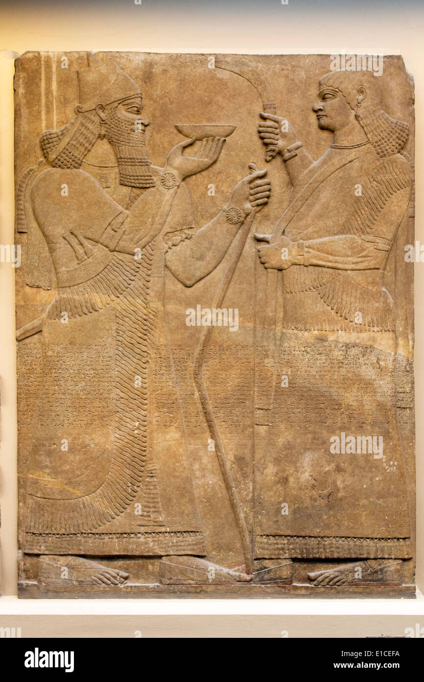 Assyrian court scene of King Ashurnasirpal Nimrud North West Palace, British Museum, London,  UK. Stock Photo
