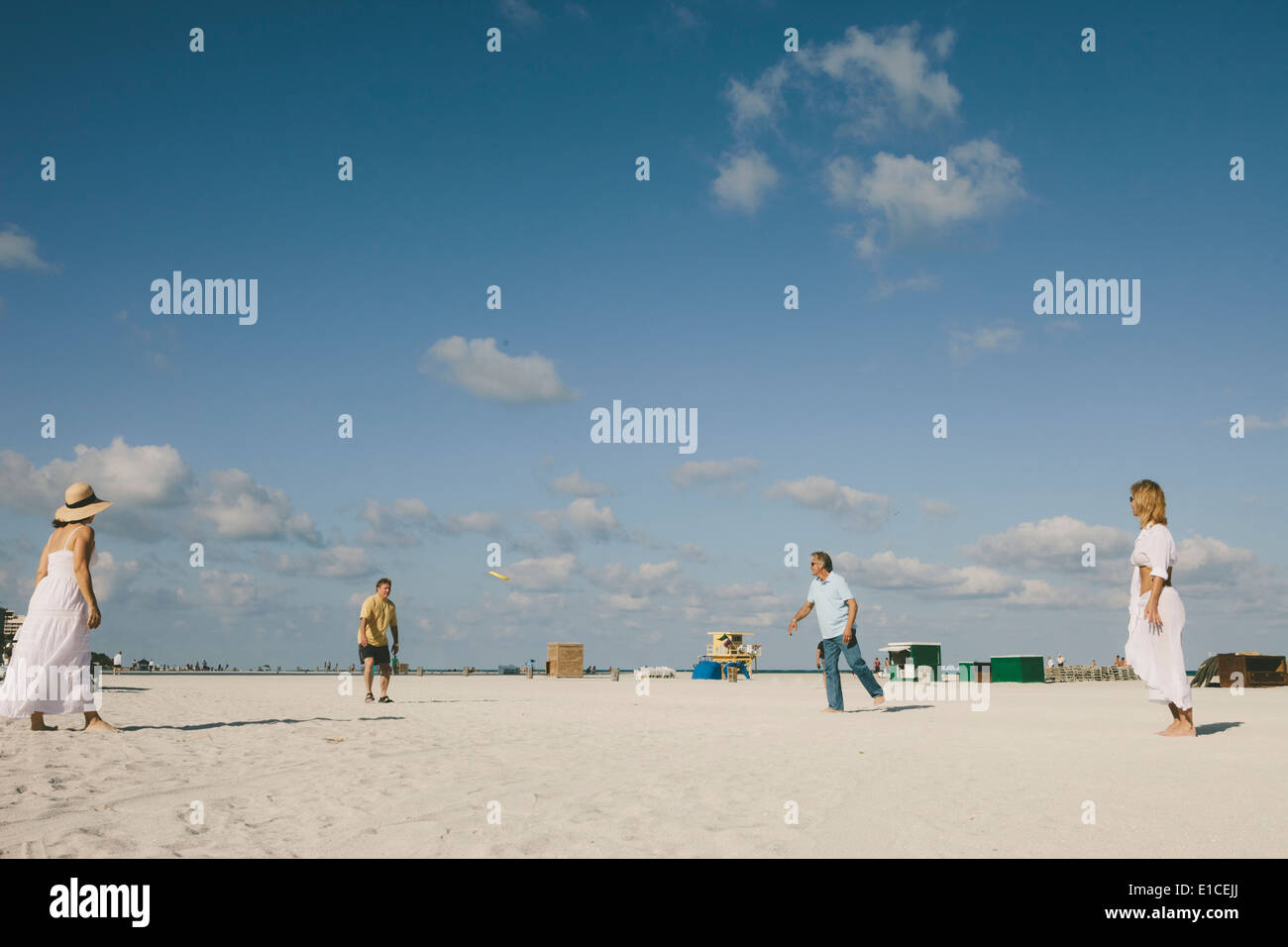 Senior citizens having fun playing frisbee at beach Stock Photo
