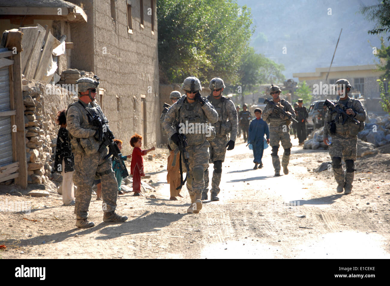 U.S. Soldiers conduct a dismounted patrol in a village near Forward