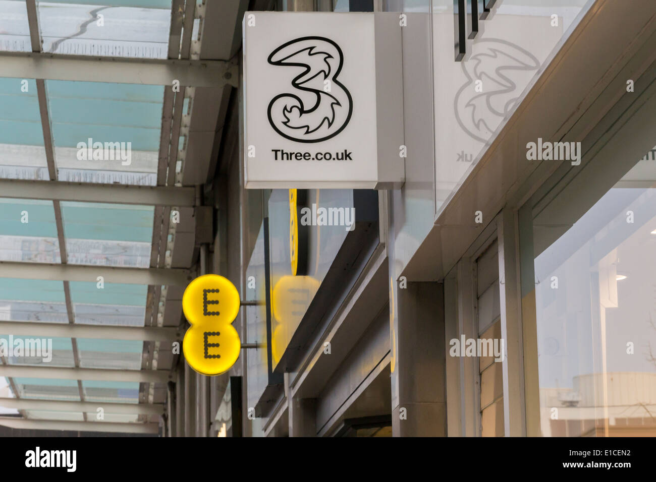EE and Three mobile phone signs Stock Photo Alamy