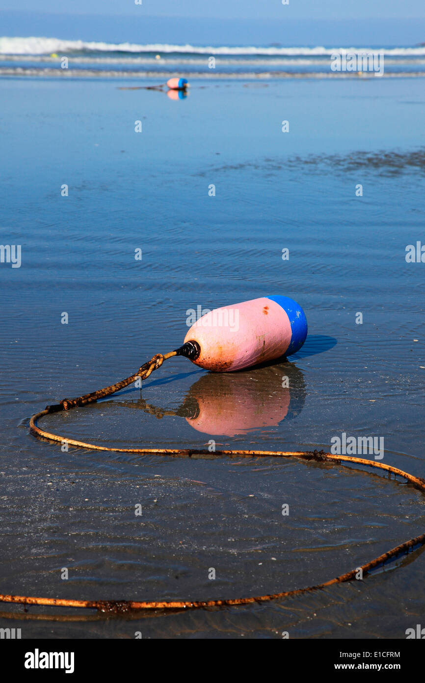 buoy attached to a rope on long beach Stock Photo