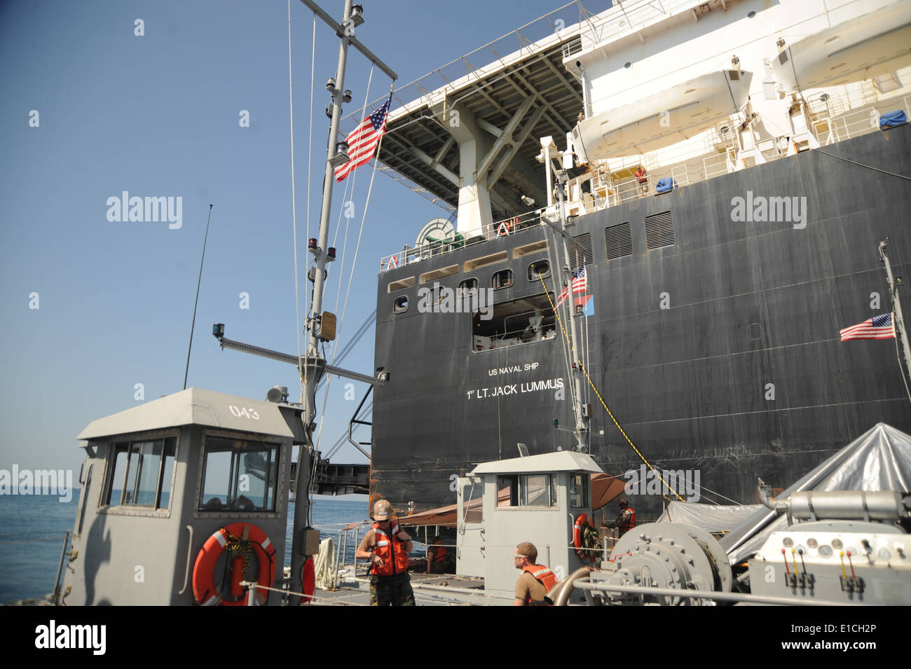 U.S. Sailors attached to Amphibious Construction Battalion 2, Little Creek, Va., pull alongside maritime prepositioning ship US Stock Photo