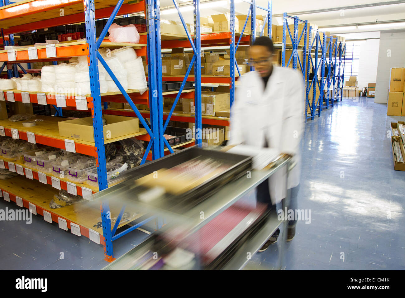 A South African employee working among rows of shelves in a warehouse