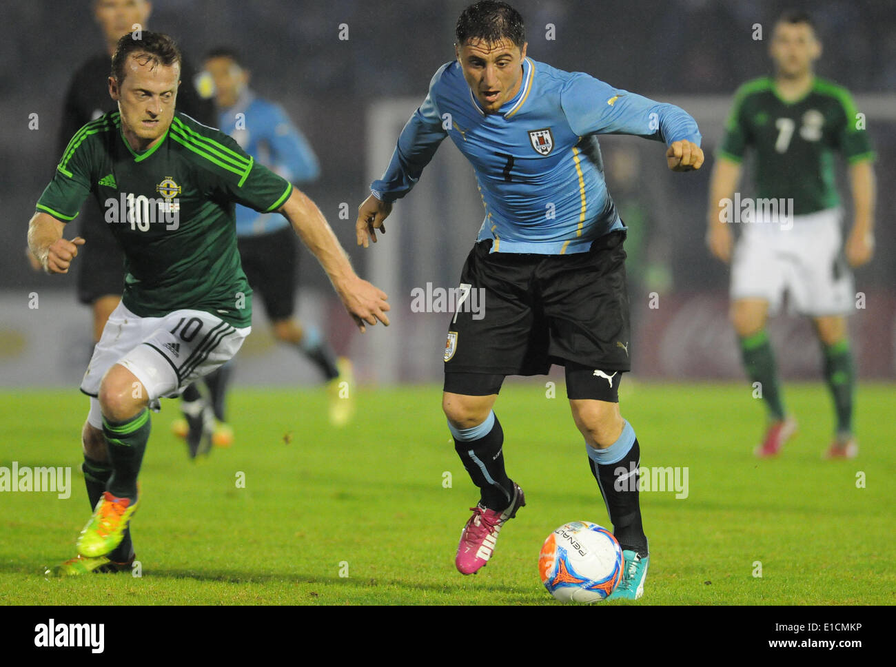 (140531) -- MONTEVIDEO, May 31, 2014 (Xinhua) -- Cristian Rodriguez (R) of Uruguay, vies for the ball with Samuel Clingan of North Ireland during a friendly match at Centenario Stadium, in Montevideo, capital of Uruguay, on May 30, 2014.  (Xinhua/Nicolas Celaya) (rh) Stock Photo