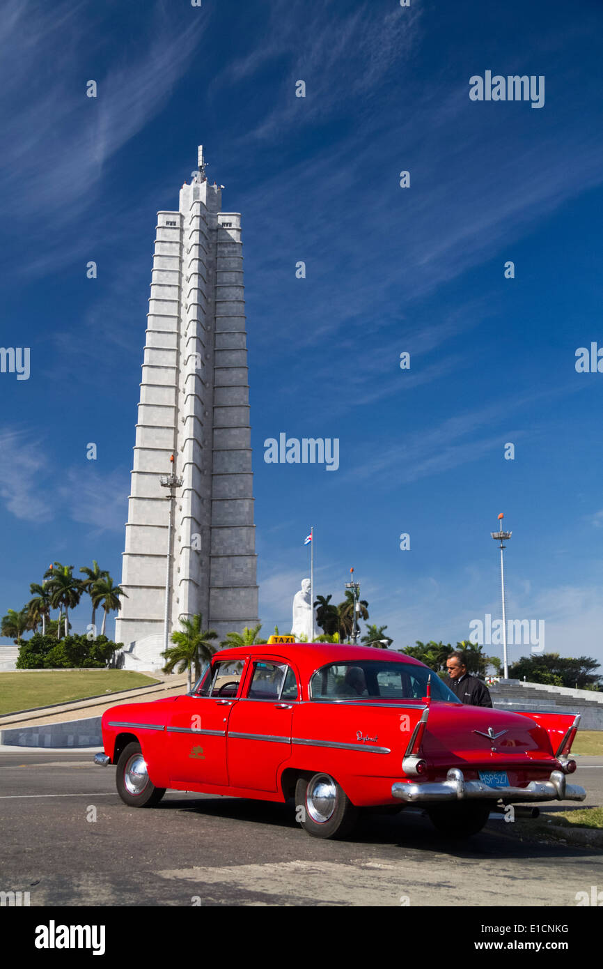 Red 1950s Chrysler DeSoto Diplomat and driver , in front of the Jose Marti Memorial statue in Havana, Cuba Stock Photo