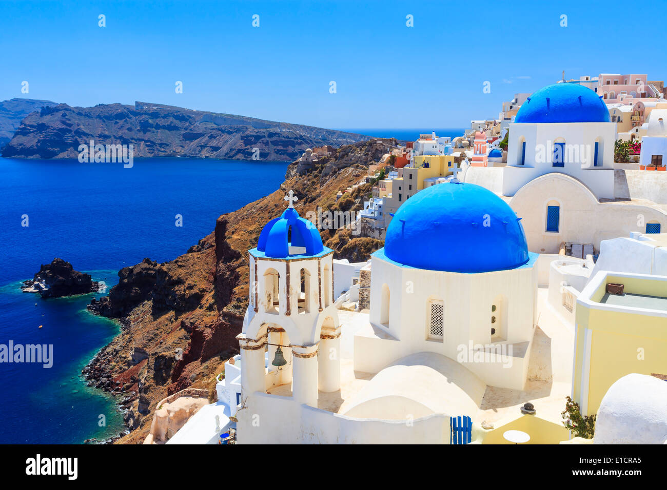Blue domed churches on the Caldera at Oia on the Greek Island of Santorini. Stock Photo