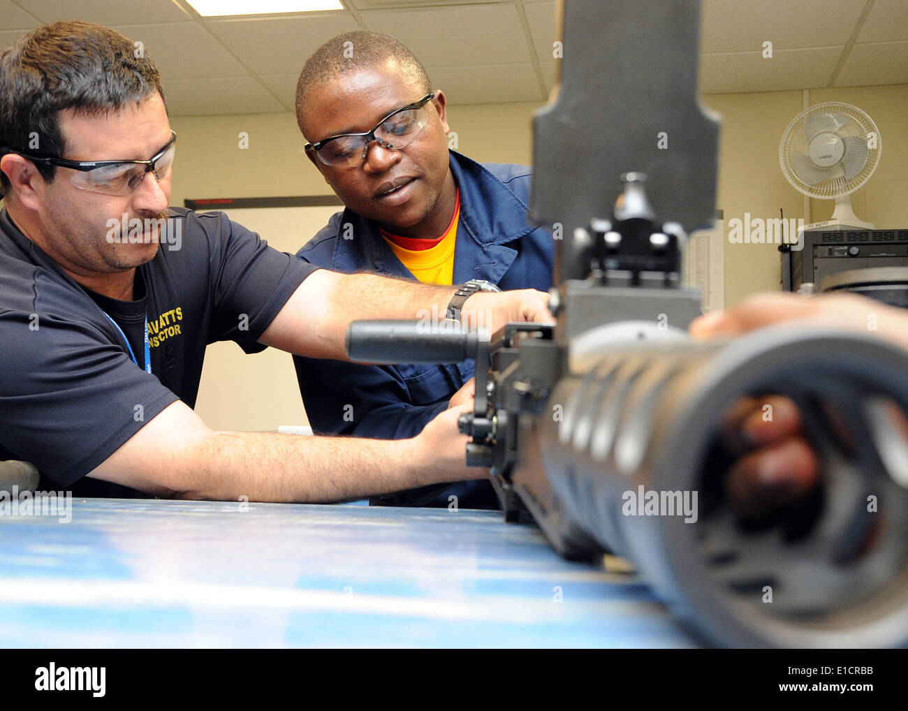Carlos Roundy, left, a patrol craft weapons maintenance instructor, teaches Cameroonian Soldier 2nd Class Mani Appolinaire Edmo Stock Photo