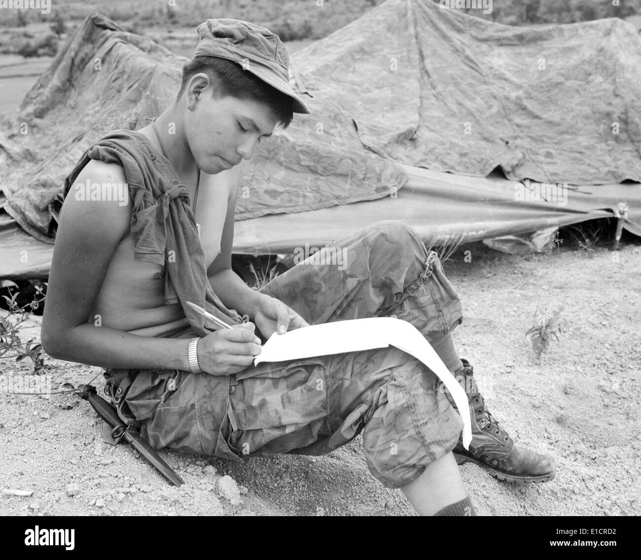 Vietnam War. Private First Class Joseph Big Medicine Jr., a Cheyenne Indian, writes a letter to his family in the United Stock Photo