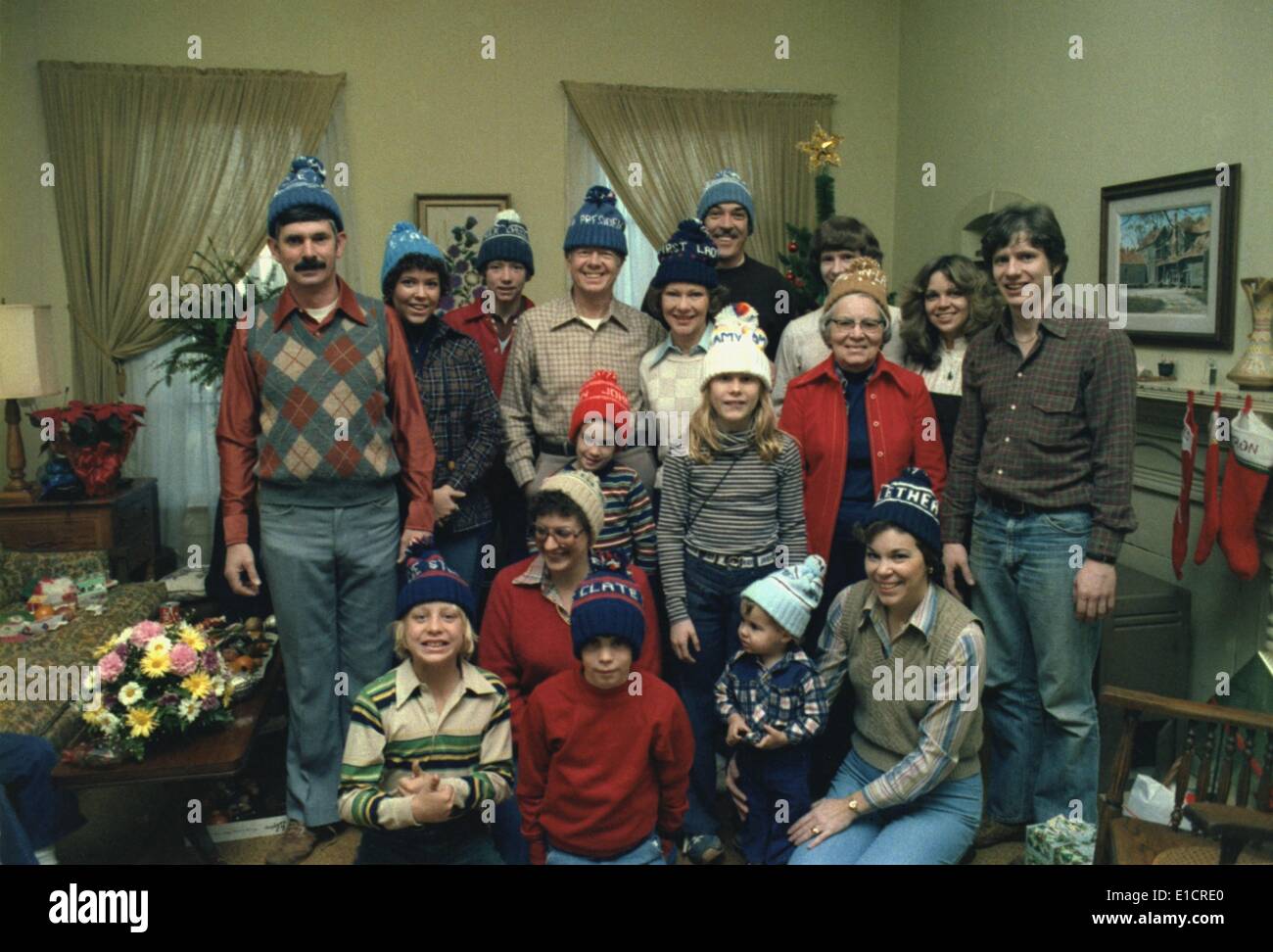 President Jimmy Carter and his large family, all wearing hats customized with their names, in the living room of their Plains, Stock Photo