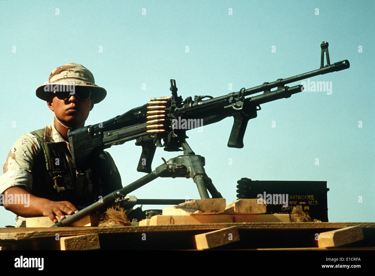 A machine gunner mans a 7.62mm M-60 machine gun as he stands guard behind a bunker during Operation Desert Shield. 4/1/1992 Stock Photo