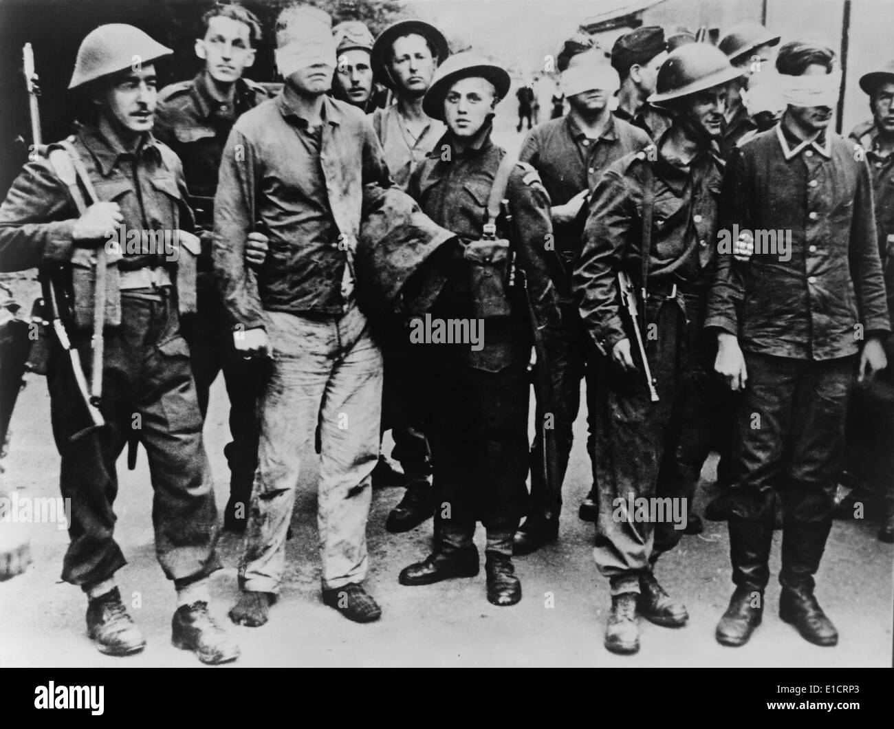 German POWs captured in the Dieppe Raid of August 19, 1942. Allied soldiers stand guard over blindfolded German prisoners, a Stock Photo