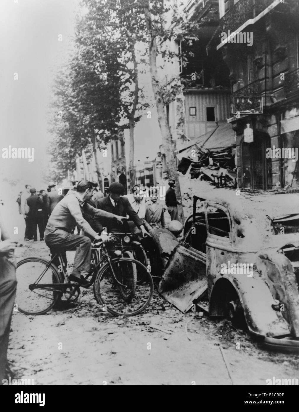 Parisians gather around a car and a home destroyed by German bombs. World War 2, ca. May-June 1940. (BSLOC 2013 11 61) Stock Photo