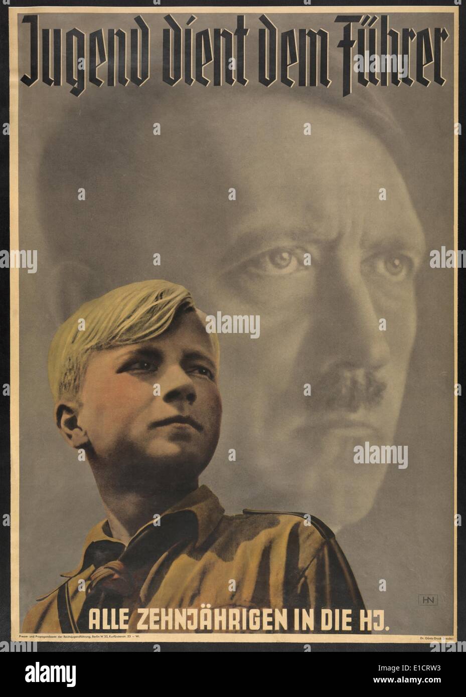 'Youth serves the leader - all ten year-olds into the Hitler Youth'. Poster shows German boy wearing Hitler Youth uniform, with Stock Photo