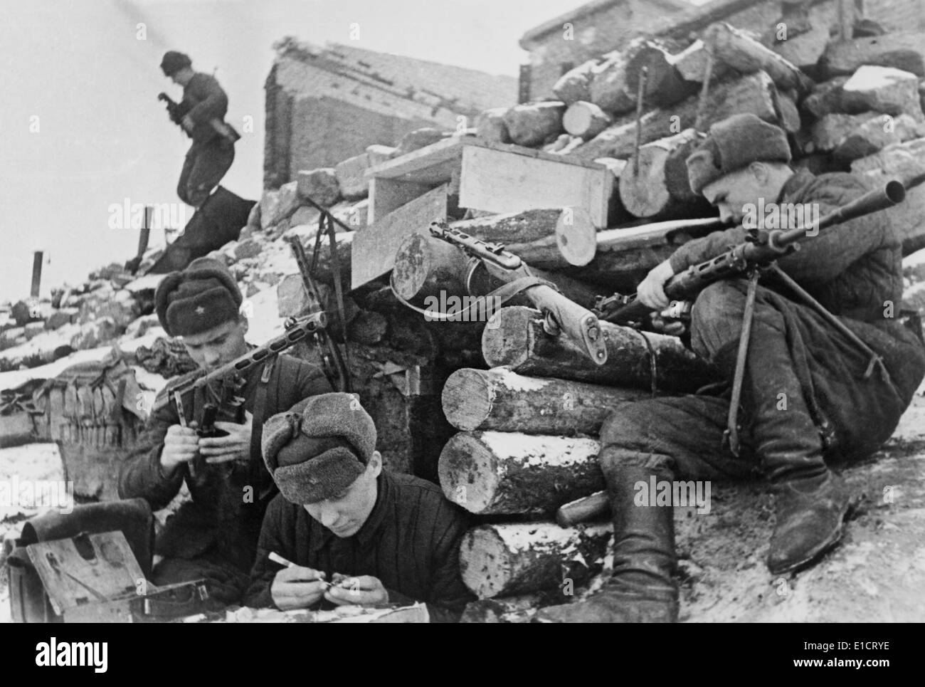 Battle for Stalingrad, World War 2. Soviet troops, at a fortified position, cleaning their weapons. The soldier in foreground Stock Photo