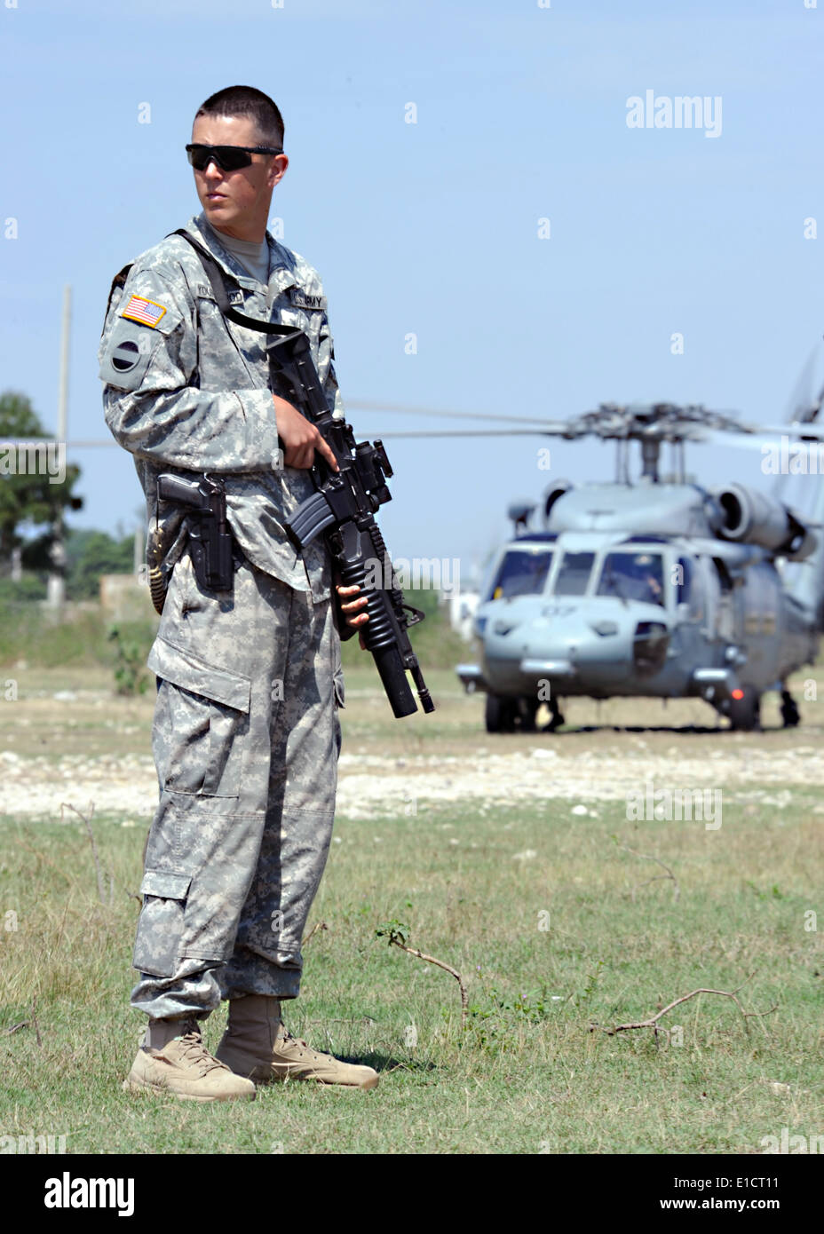 U.S. Army Cpl. Jay Youngblood provides security at a landing zone near the U.S. Embassy in Port-au-Prince, Haiti, March 8, 2010 Stock Photo