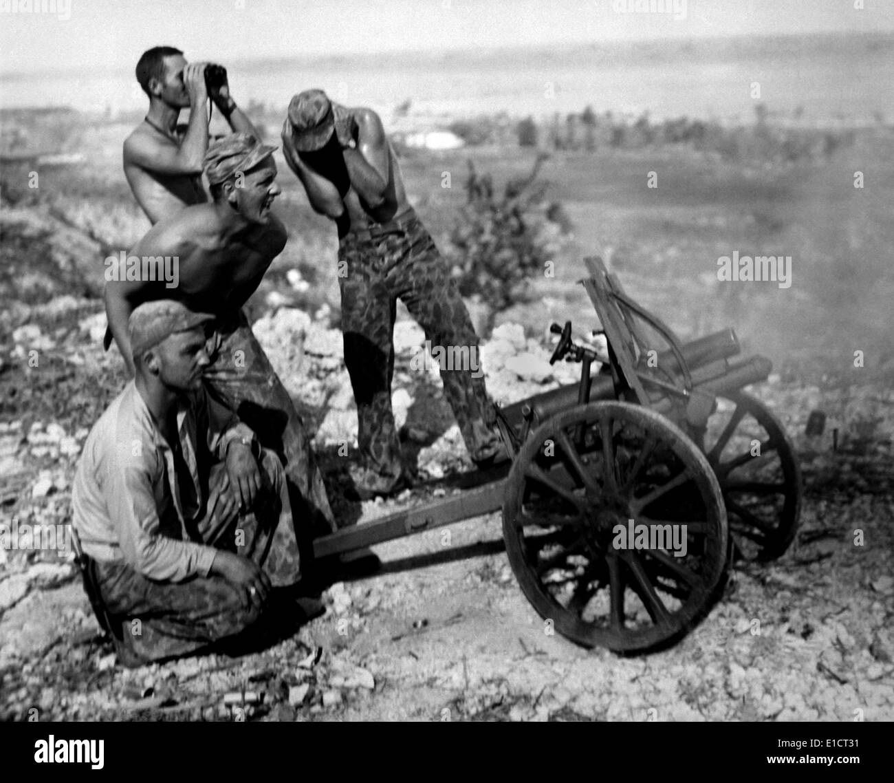 Marines fire a captured Japanese mountain gun in Garapan, Saipan, July 1944. (BSLOC 2013-12 212) Stock Photo