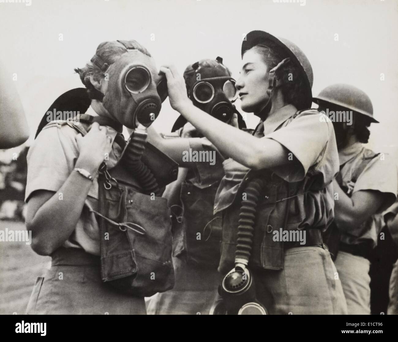 South African Women's Auxiliary Services sergeant is fitted with a gas mask. Unknown location during World War 2. April 1942. Stock Photo