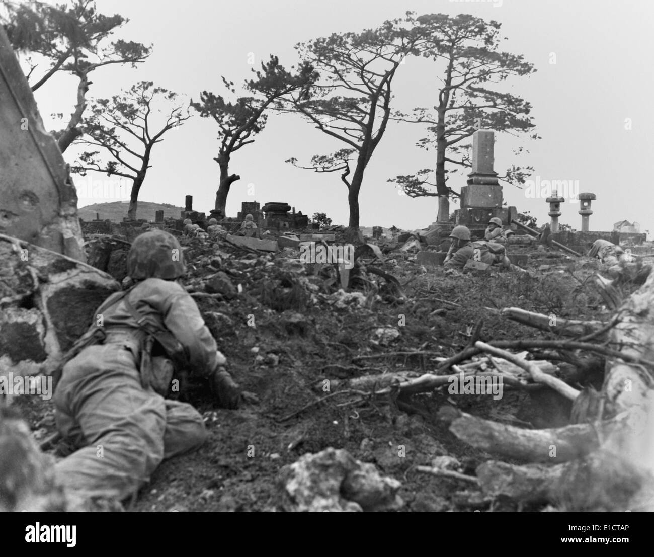 Marines pinned down behind gravestones by Japanese snipers during the Battle of Okinawa. June 1, 1945. World War 2. Stock Photo