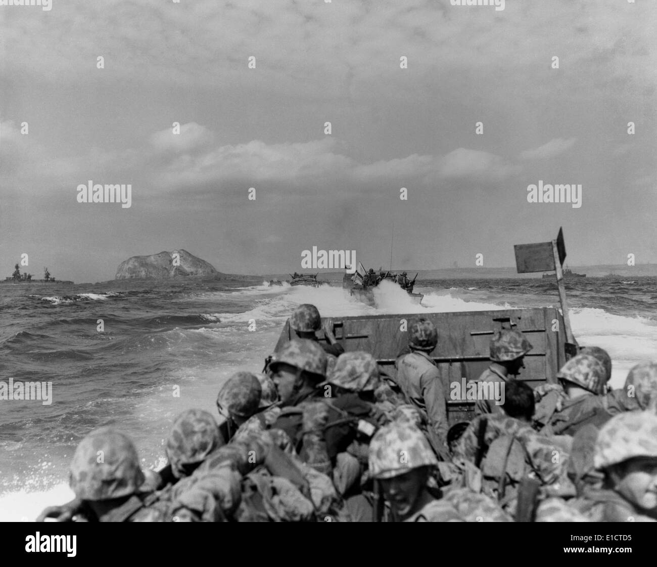 LCVP’s (Landing Craft, Vehicle, Personnel -LCVP) or Higgins boats, approaching Iwo Jima. In the distance is Mount Suribachi. Stock Photo