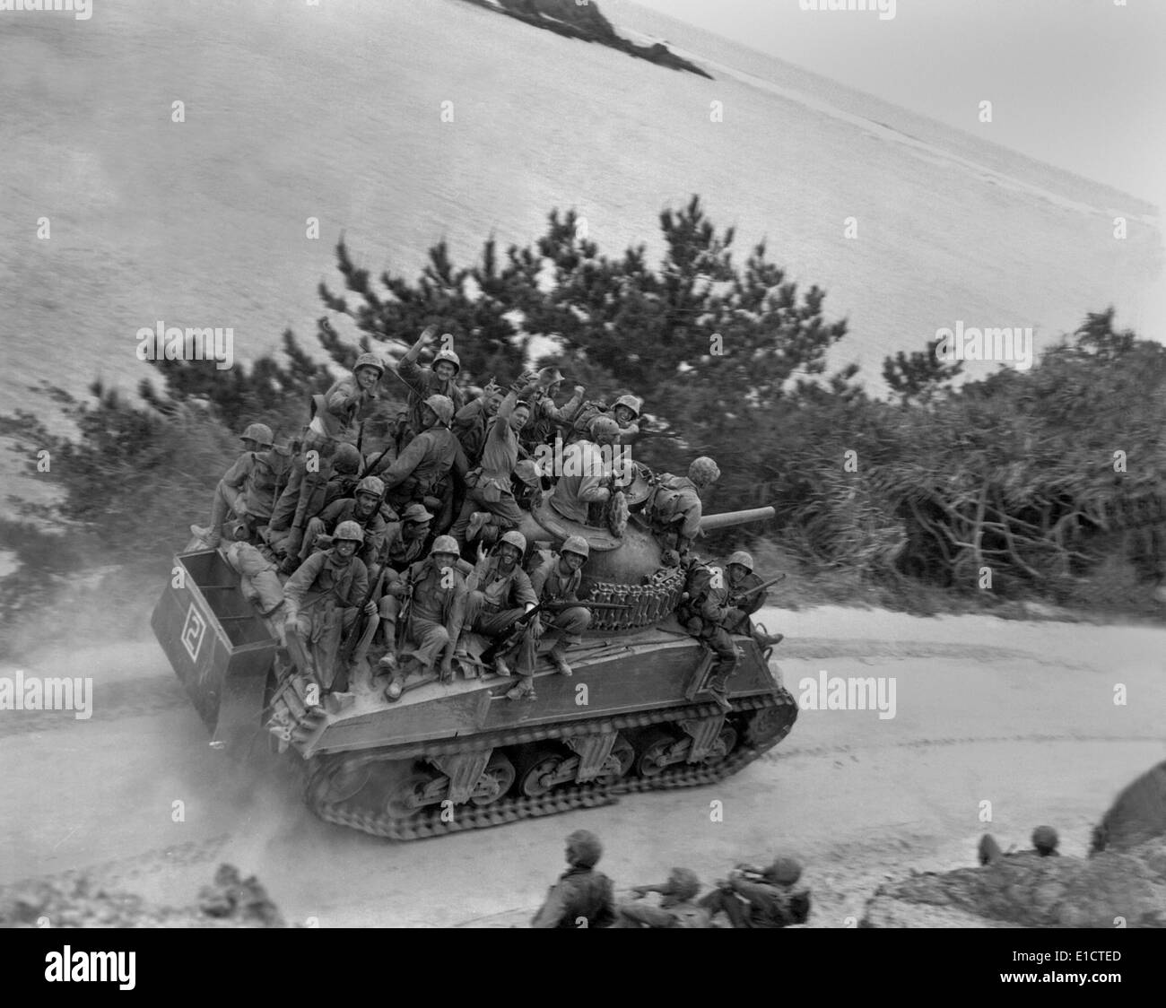 Soldiers of the 29th Marines on a Sherman tank on the first day of the invasion of Okinawa. April 1, 1945. They are advancing Stock Photo