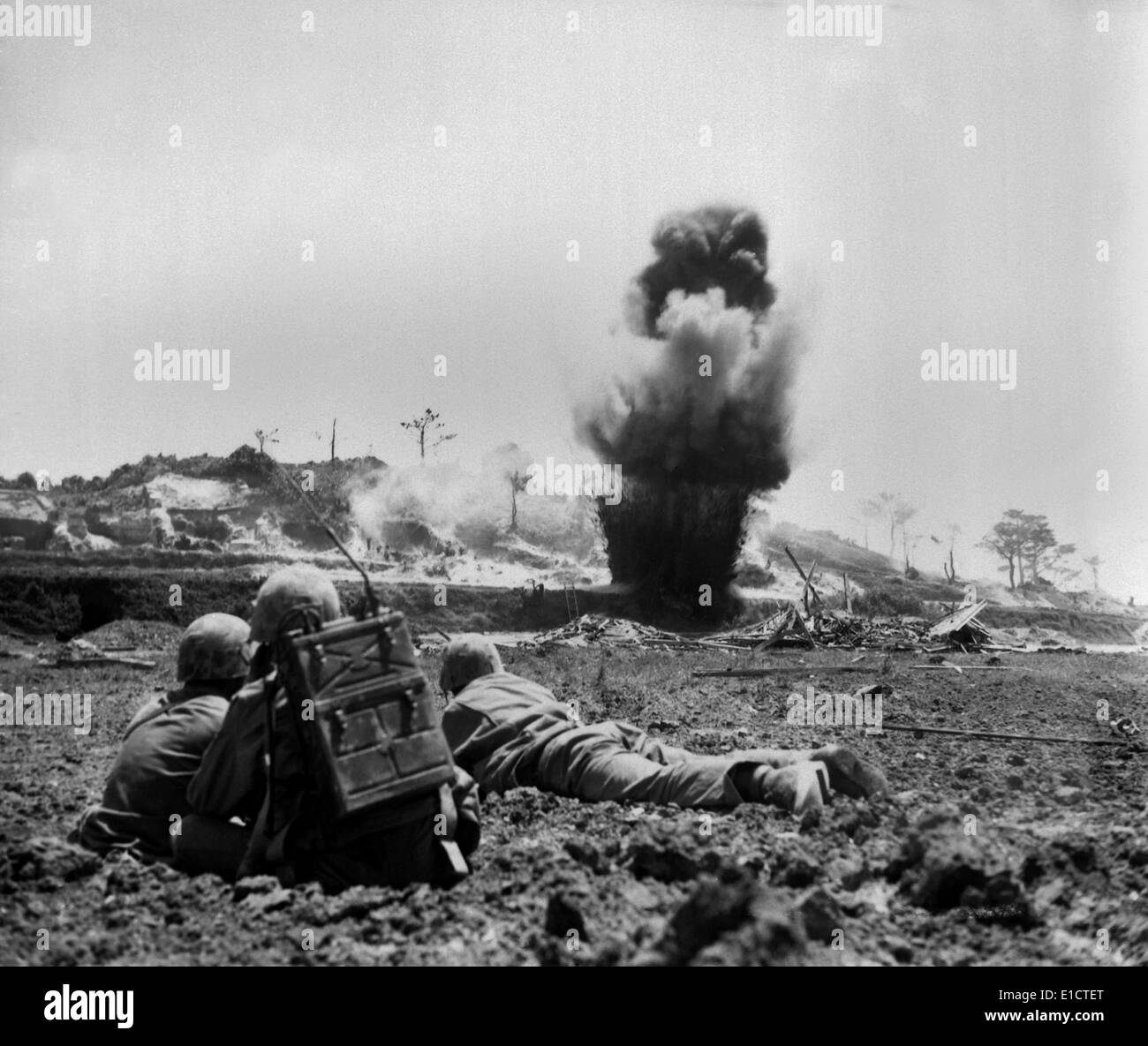 Marine demolition crew watch dynamite charges explode and destroy a Japanese cave. 6th Marine Division, May 1945. World War 2. Stock Photo