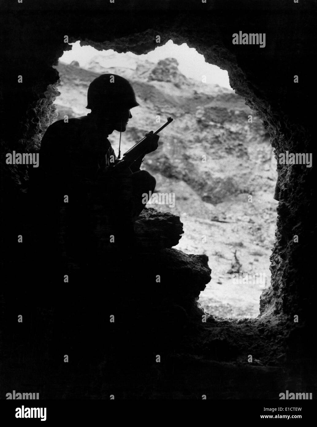 Marine rifleman positioned in an cave to pick off Japanese snipers in ...