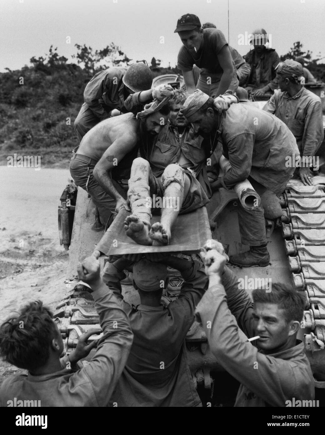 Wounded Marine is removed from a tank that carried him from the front lines on Okinawa. Fierce Japanese resistance made it Stock Photo