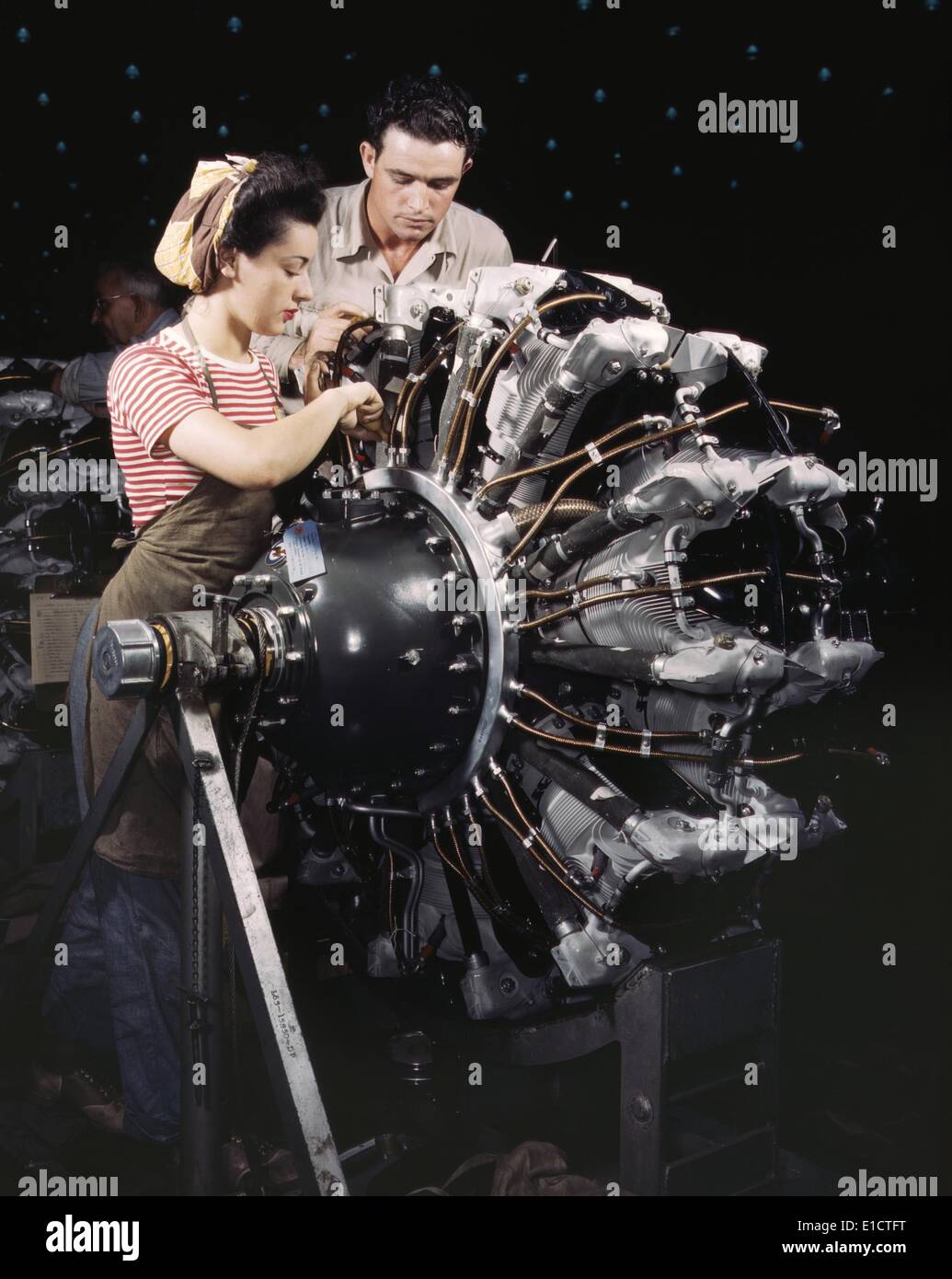 Woman war worker in training as an engine mechanic at Douglas Aircraft Company. Long Beach, California during World War 2, ca. Stock Photo