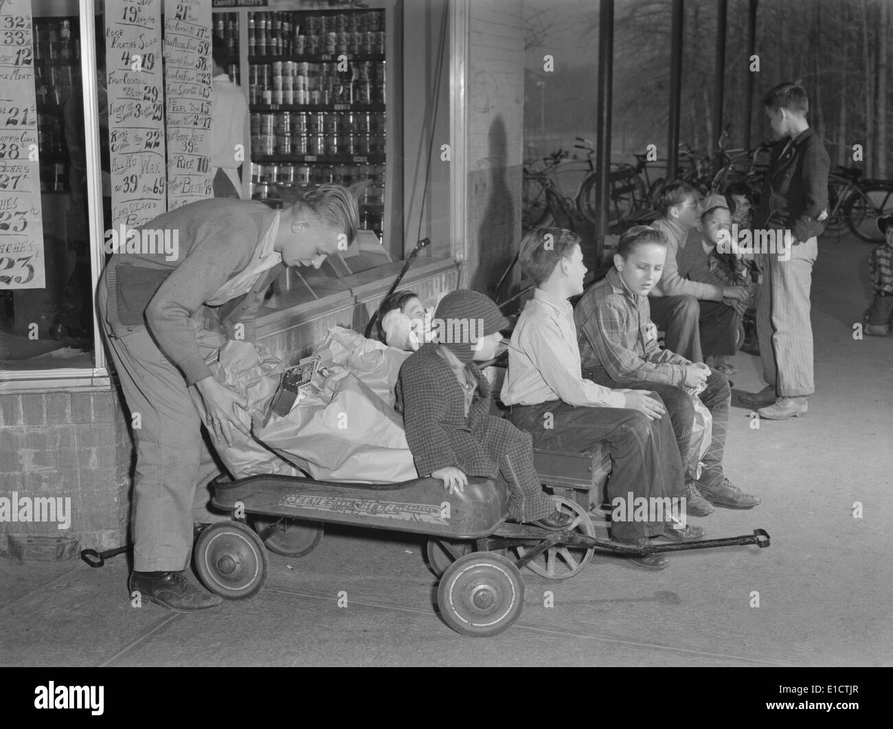 Youngsters hiring out their express wagons to haul groceries in suburban Greenbelt, Maryland. World War 2 tire and gasoline Stock Photo