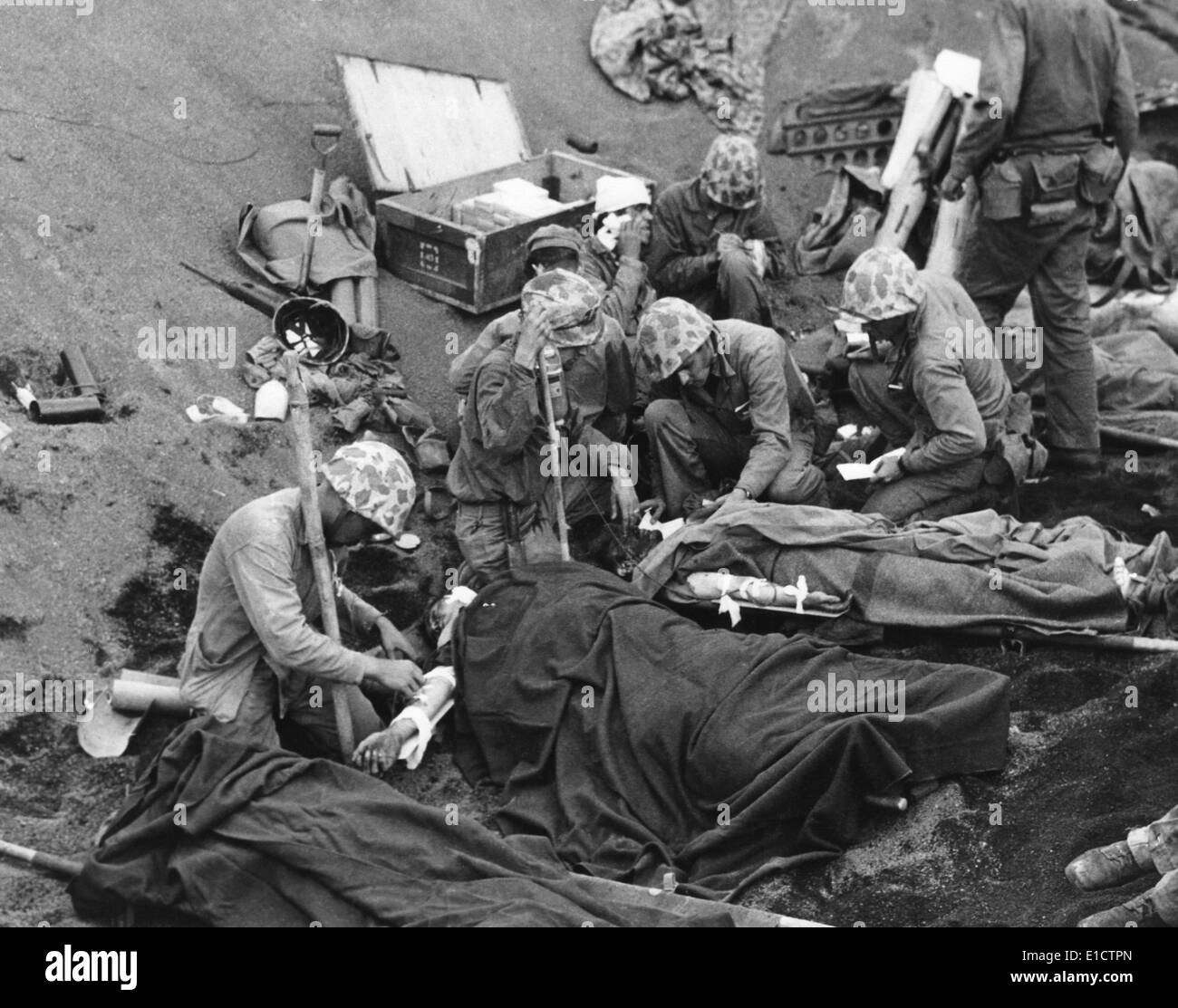 Navy doctors and corpsmen treat seriously wounded Marines on Iwo Jima. Feb. 19-March 26, 1945, during World War 2. Stock Photo