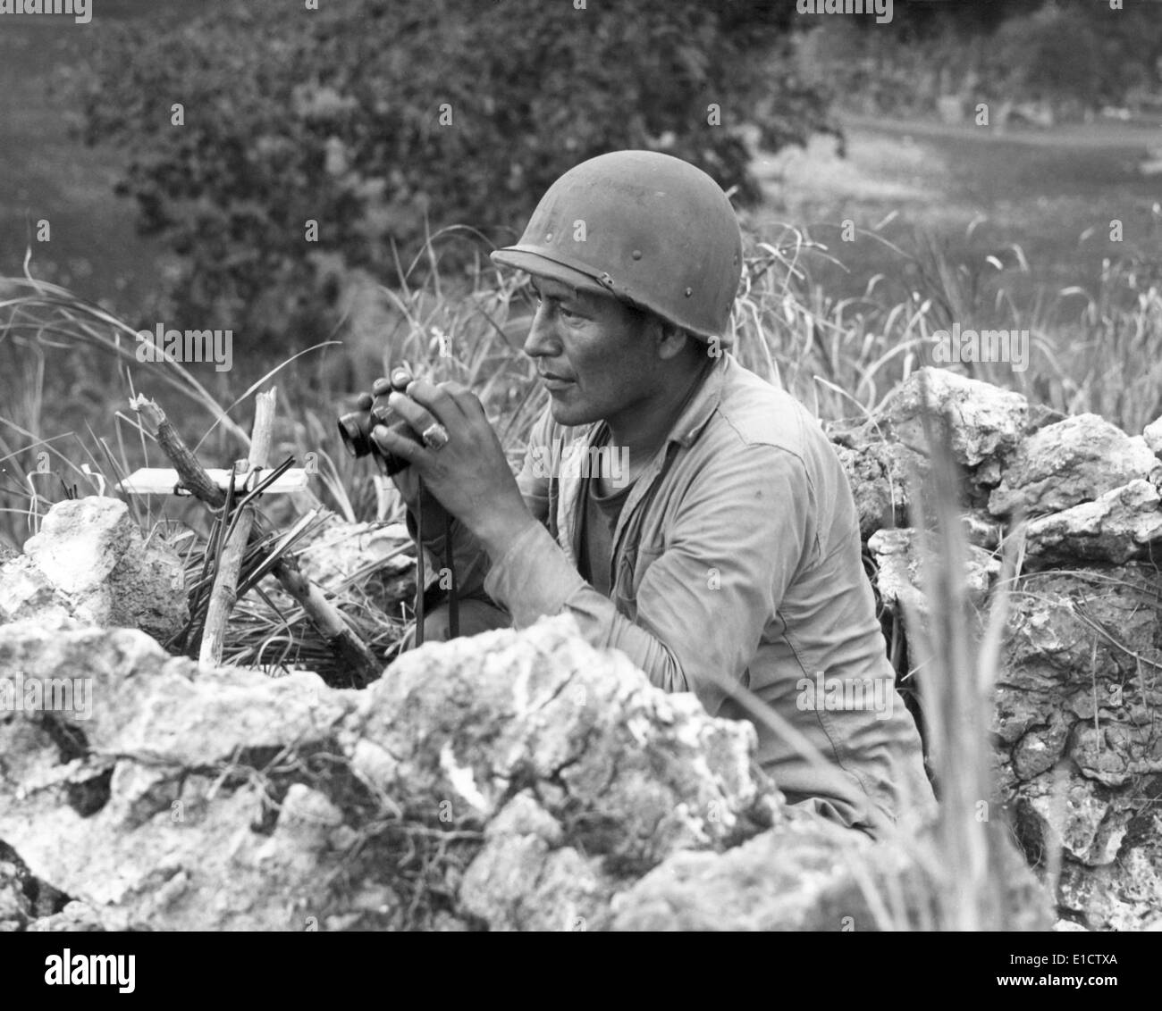 Native American Marine 'Code Talker' at an observation post overlooking the city of Garapan. During the Battle of Saipan. June Stock Photo