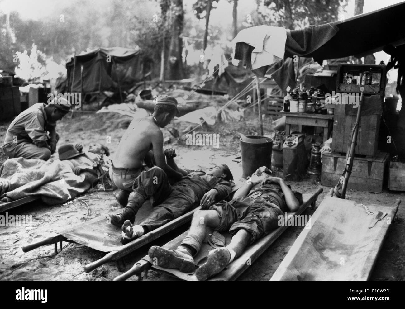 U.S. Army medics treat wounded soldiers at a portable surgical unit in Burma. Soldiers are from the 36th Division's World War 2 Stock Photo