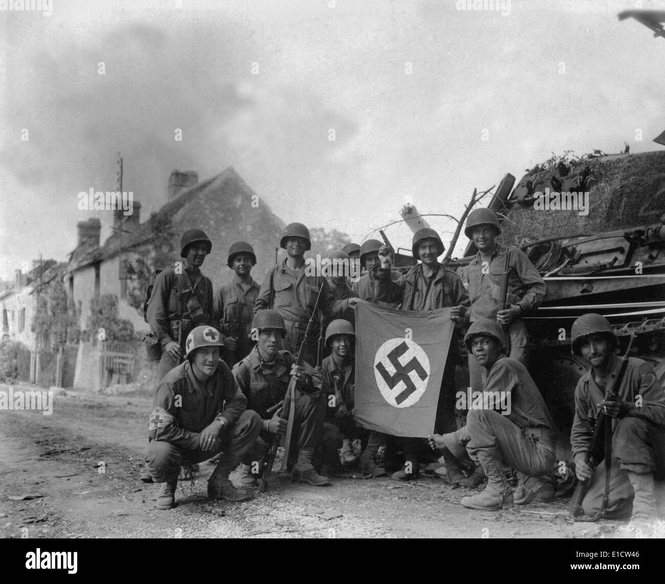 U.S. Soldiers display a captured swastika flag on August 20, 1944. Two days after the Battle of the Falaise Pocket, they were Stock Photo