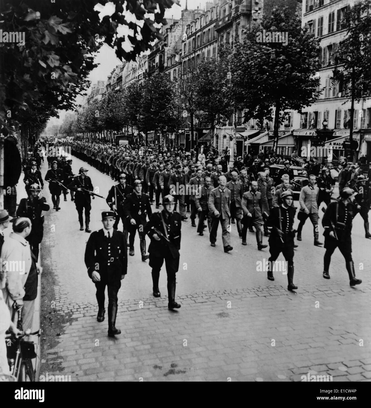 German prisoners march through the streets of Paris, under the guard of French police. August 19-24, 1944, World War 2. Stock Photo