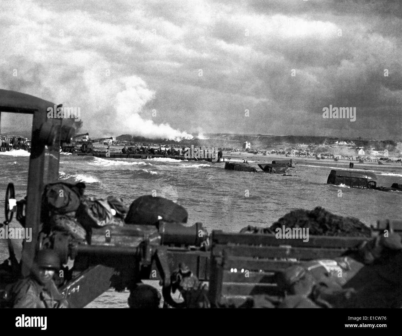 U.S. landing craft approaching Omaha Beach in Normandy beach on Dec. 6, 1944. Soldiers are standing on ships decks, indicating Stock Photo