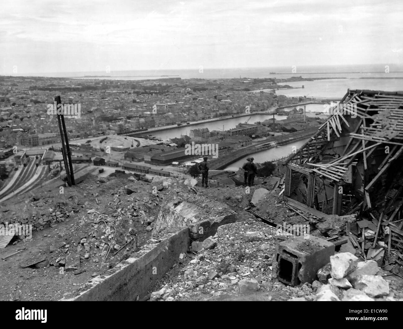 Three GI's view the port city of Cherbourg after the capture of Fort du Roule. June-July 1944. Normandy Campaign, France, World Stock Photo