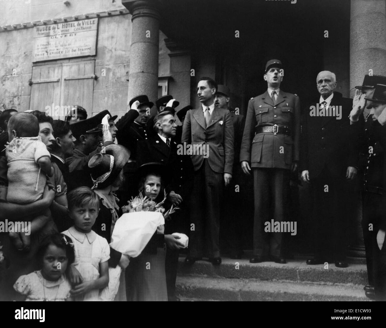 General Charles DeGaulle in Cherbourg to establish a government for liberated France. Standing on the steps if City Hall, R to Stock Photo