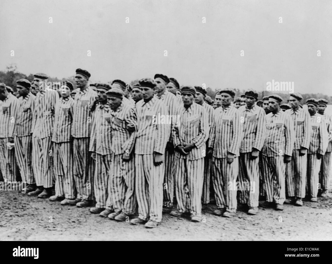 Roll call at Buchenwald concentration camp, ca. 1938-1941. Two prisoners in the foreground are supporting a comrade, as Stock Photo